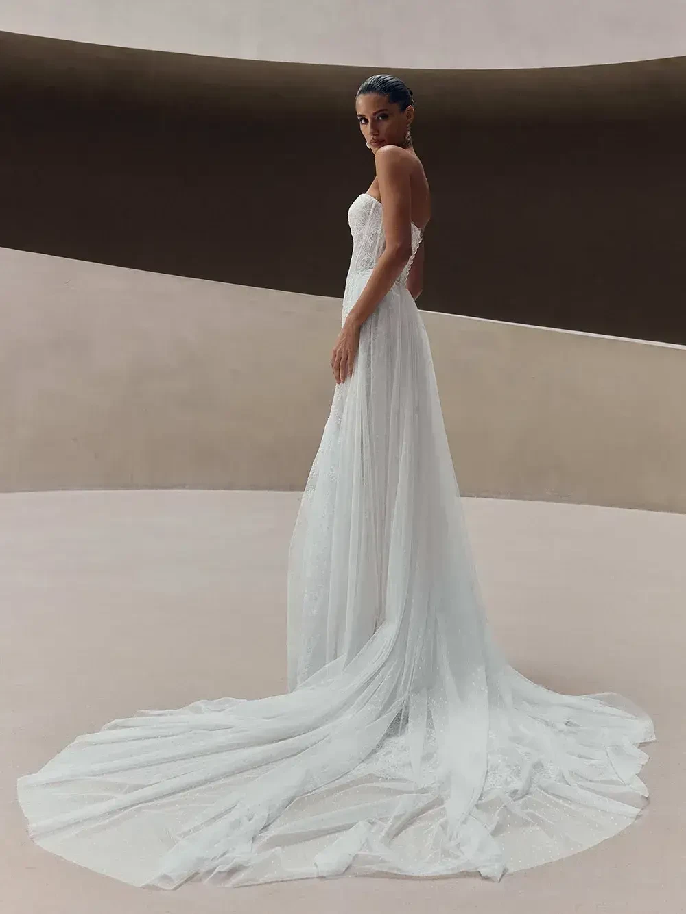 model is wearing an off the shoulder lace wedding gown