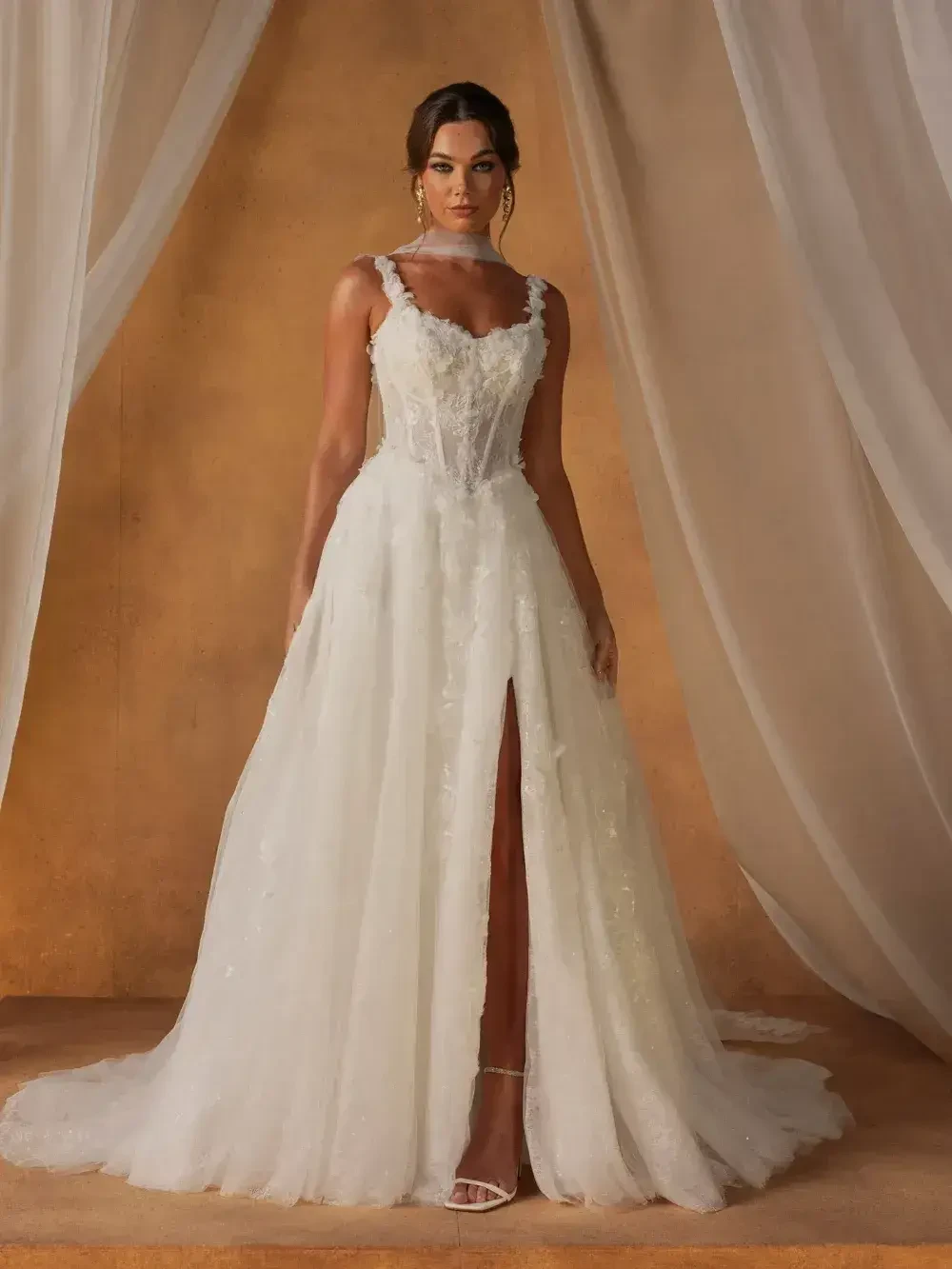 model is wearing a sleeveless a-line wedding gown