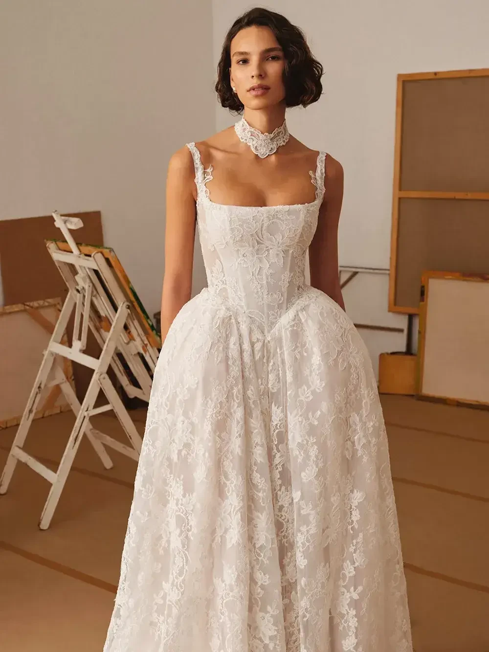 model is wearing a spaghetti strap sleeveless bridal gown