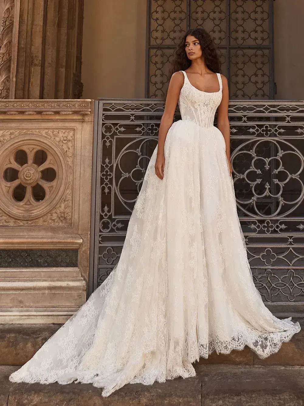 model is wearing a sleeveless a-line bridal gown