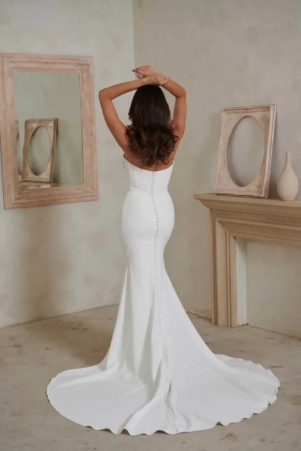 model is wearing a strapless fitted bridal gown
