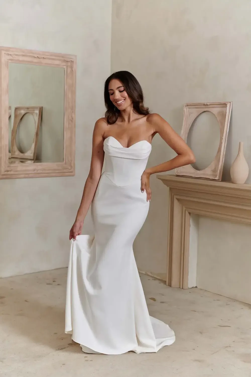 model is wearing a strapless minimalist bridal gown